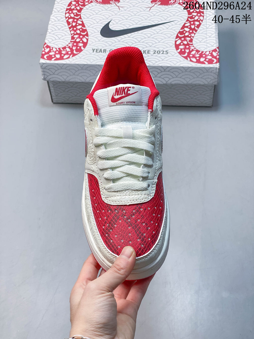 Front view of the low-top sneaker with white laces and red patterned toe panel