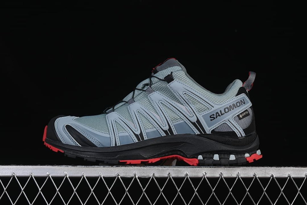 Side profile of a gray Salomon trail shoe