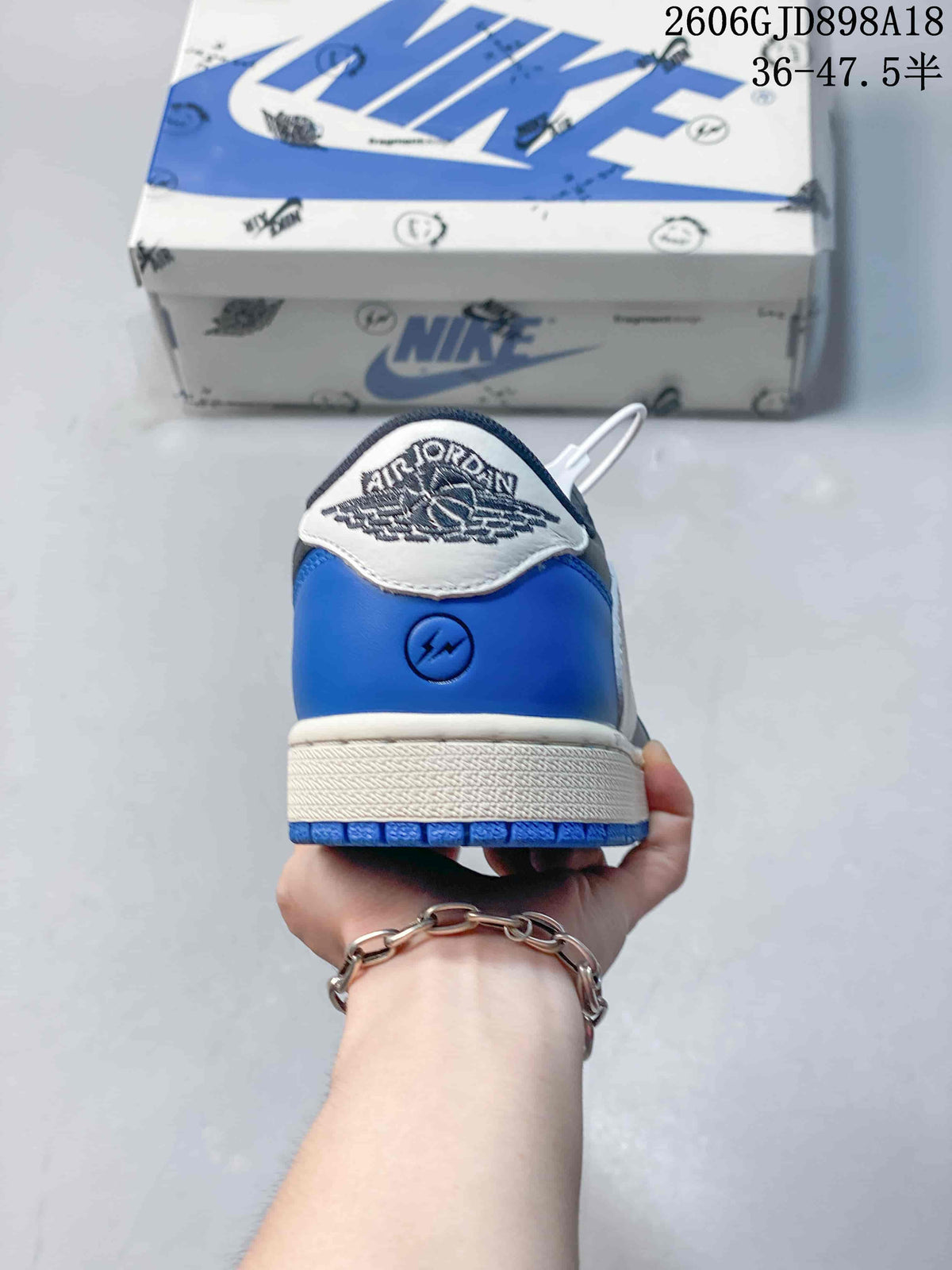 Rear view of the sneaker with blue heel panels and a white heel tab.