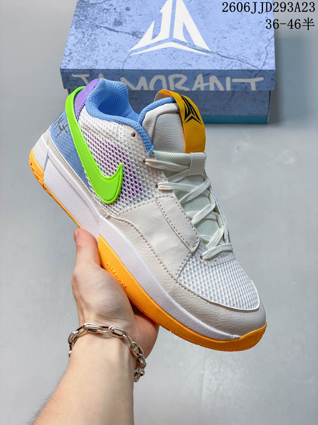White Nike Ja 1 EP shoe with blue, green and orange accents.