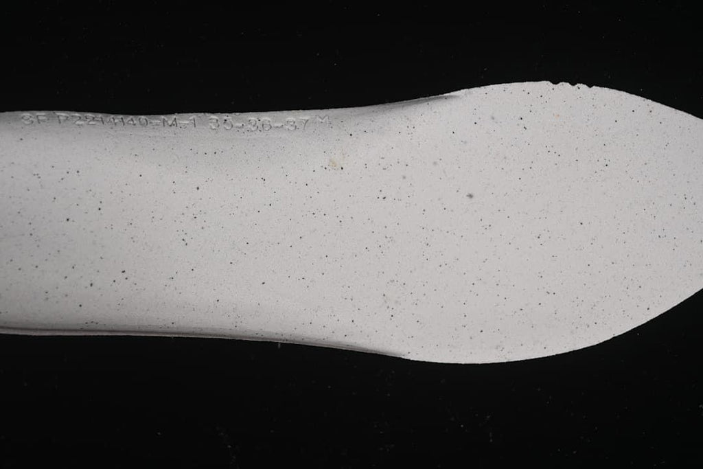 Close-up of the pale, speckled sneaker outsole.