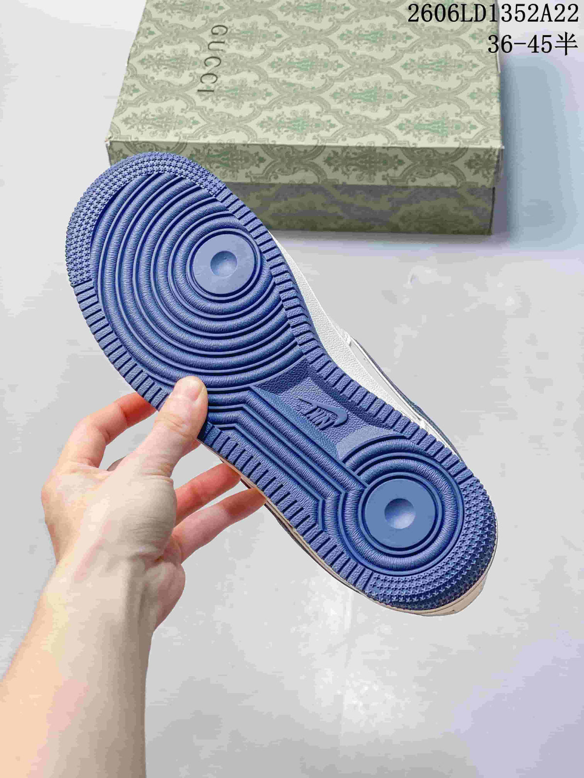 Blue outsole of a white sneaker shown beside a patterned box; image text shows style code 2606LD1352A22 and size range 36–45.5.