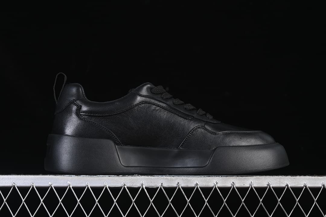 Black sneaker in side profile with a substantial sole