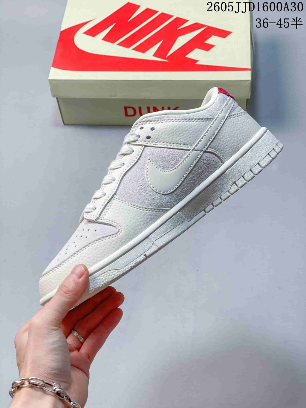 Side view of an off-white low-top sneaker showing the Swoosh and textured panels