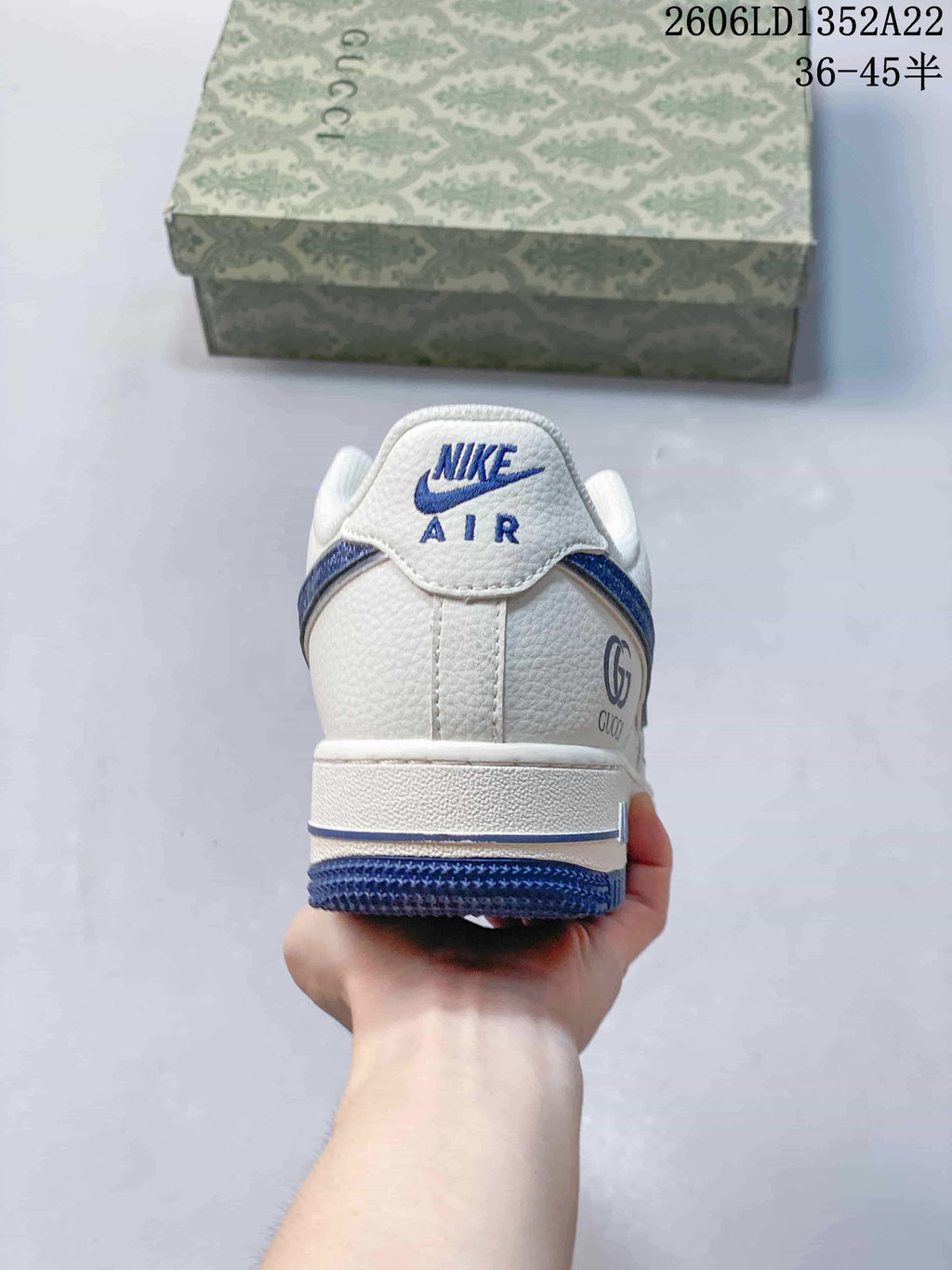 Rear view of a white sneaker with blue accents and visible Nike Air and Gucci branding; image text shows style code 2606LD1352A22 and size range 36–45.5.