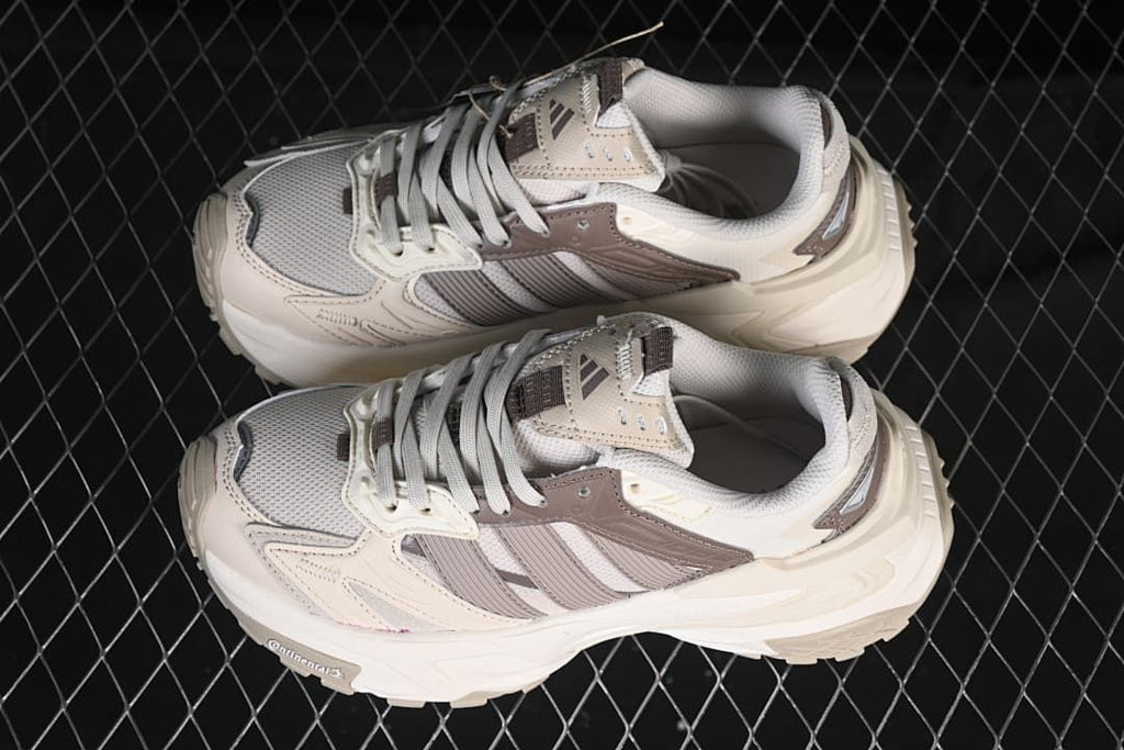 Pair of light neutral and brown XLG Storm Edge sneakers shown from above.