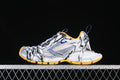 Side view of white Balenciaga 3XL sneakers with logo laces and orange outsole