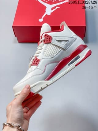 Side profile of a white and red Air Jordan 4 sneaker