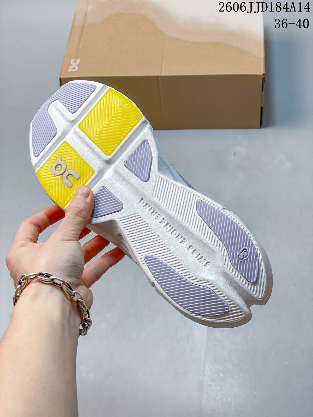 Outsole view of a grey On Cloudpulse Next running shoe with white and yellow tread details.
