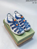 Blue and white KEEN Newport H2 sandals with orange lace details on a shoe box