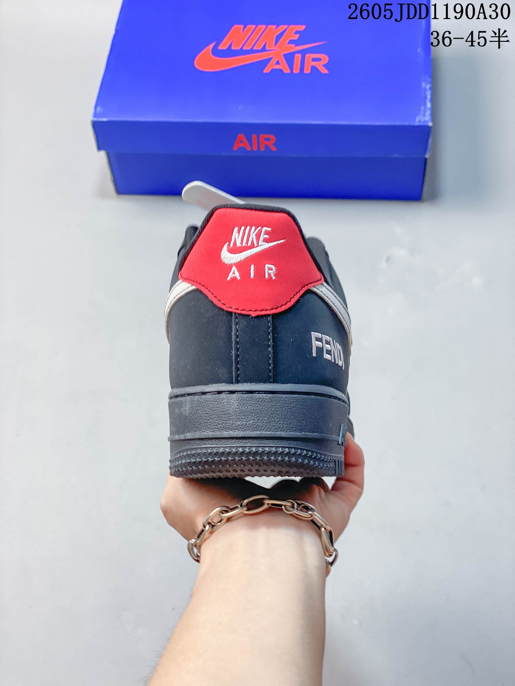 Rear view of the sneaker showing a red heel tab and dark gray heel panel.