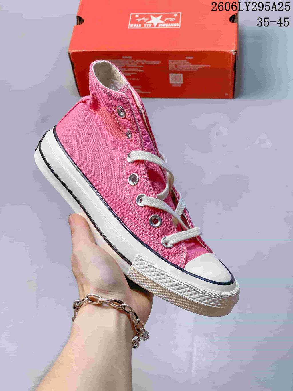 Pink Converse high-top lace-up sneaker with a white toe cap and striped sole