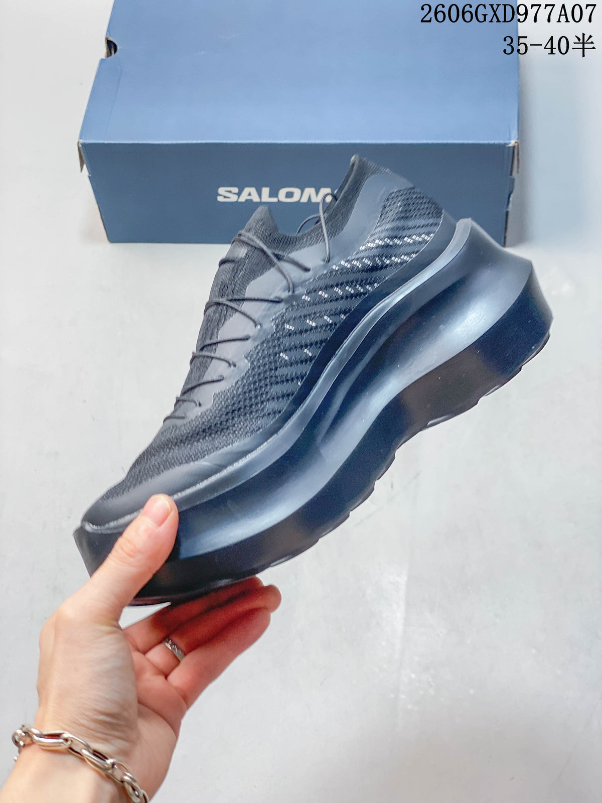 Side profile of the gray sneaker with a thick platform sole and patterned panels.
