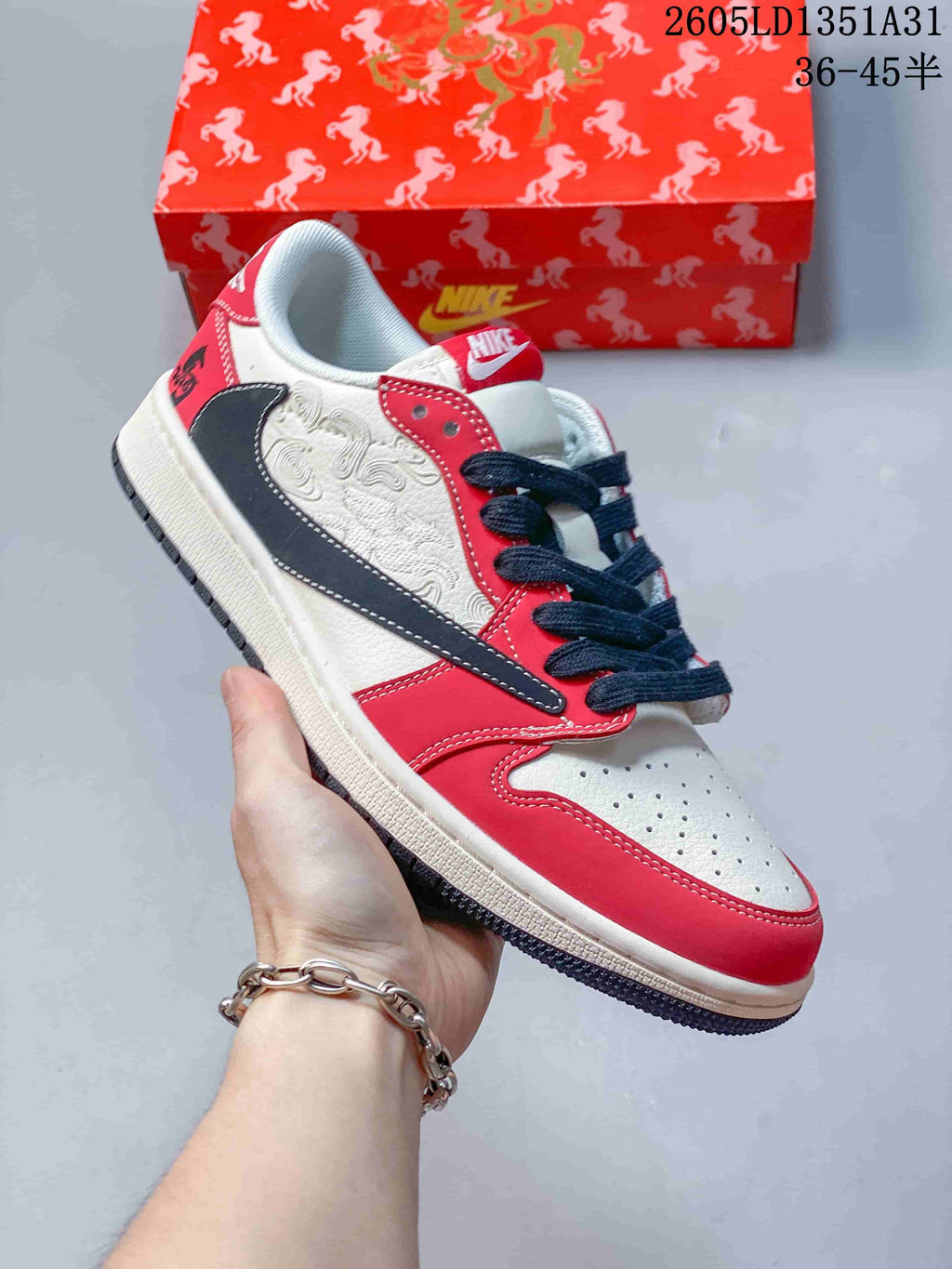 Angled side view showing cloud-like embroidery, dark swoosh, and red overlays