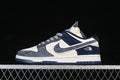 Side view of a gray, off-white, and navy low-top sneaker with patterned laces and a decorated Swoosh