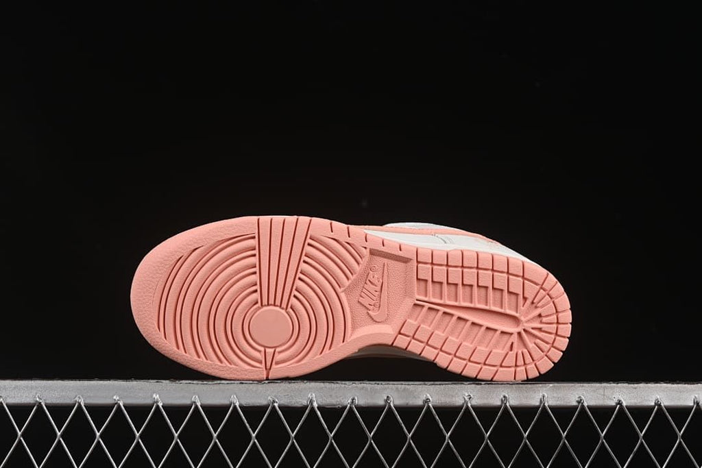 Pink outsole showing circular forefoot tread and patterned heel