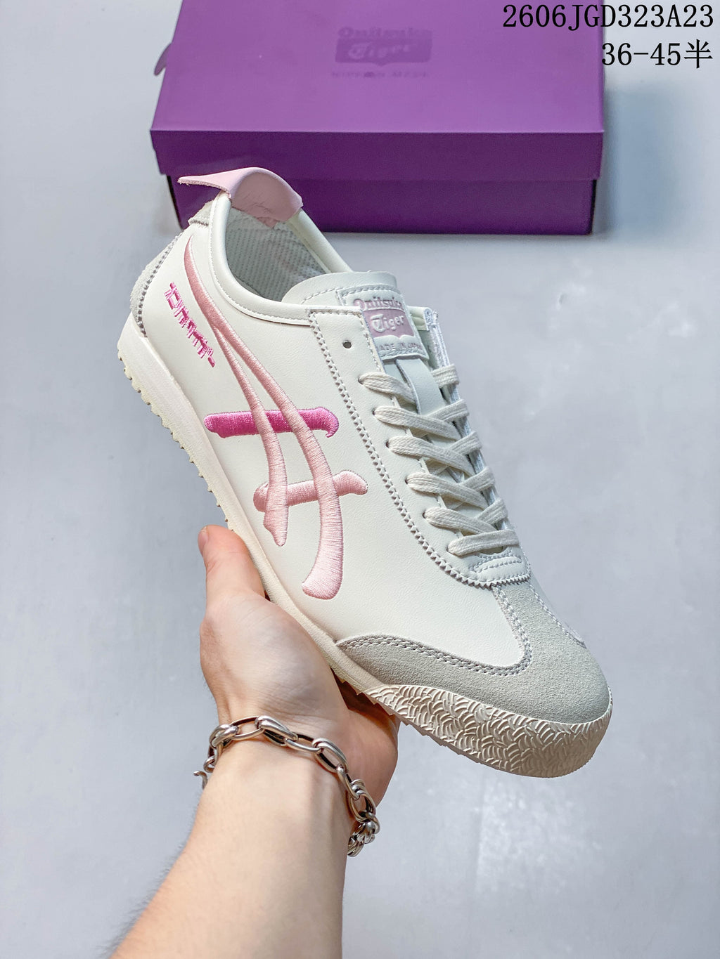 Angled side view highlighting the cream upper and pink detailing.