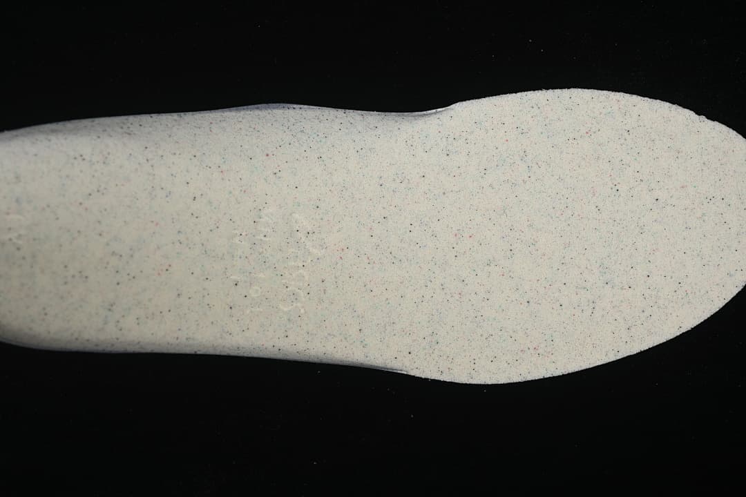 Close-up of the light-colored shoe outsole with speckled details