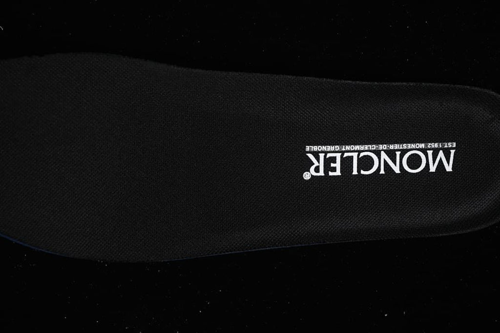 Black shoe insole with white branding