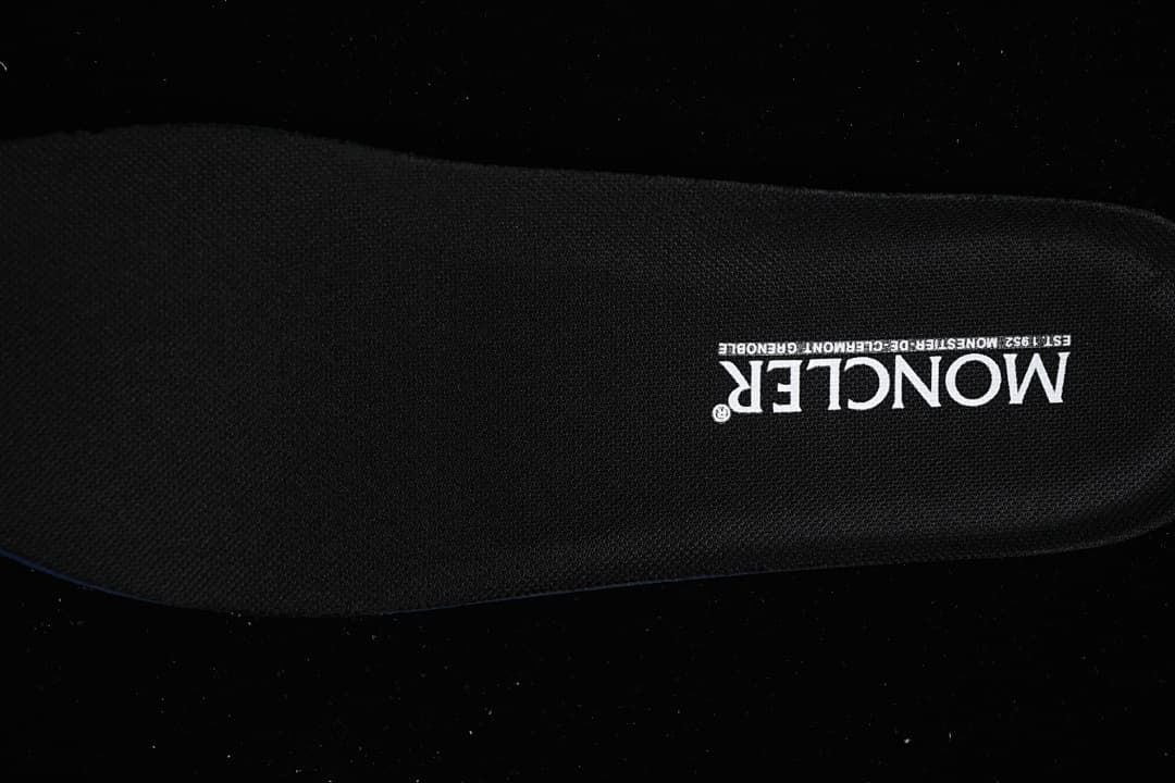 Black shoe insole with white branding