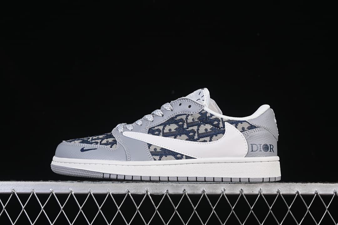 Side view of a grey and white low-top sneaker with dark patterned panels and heel lettering