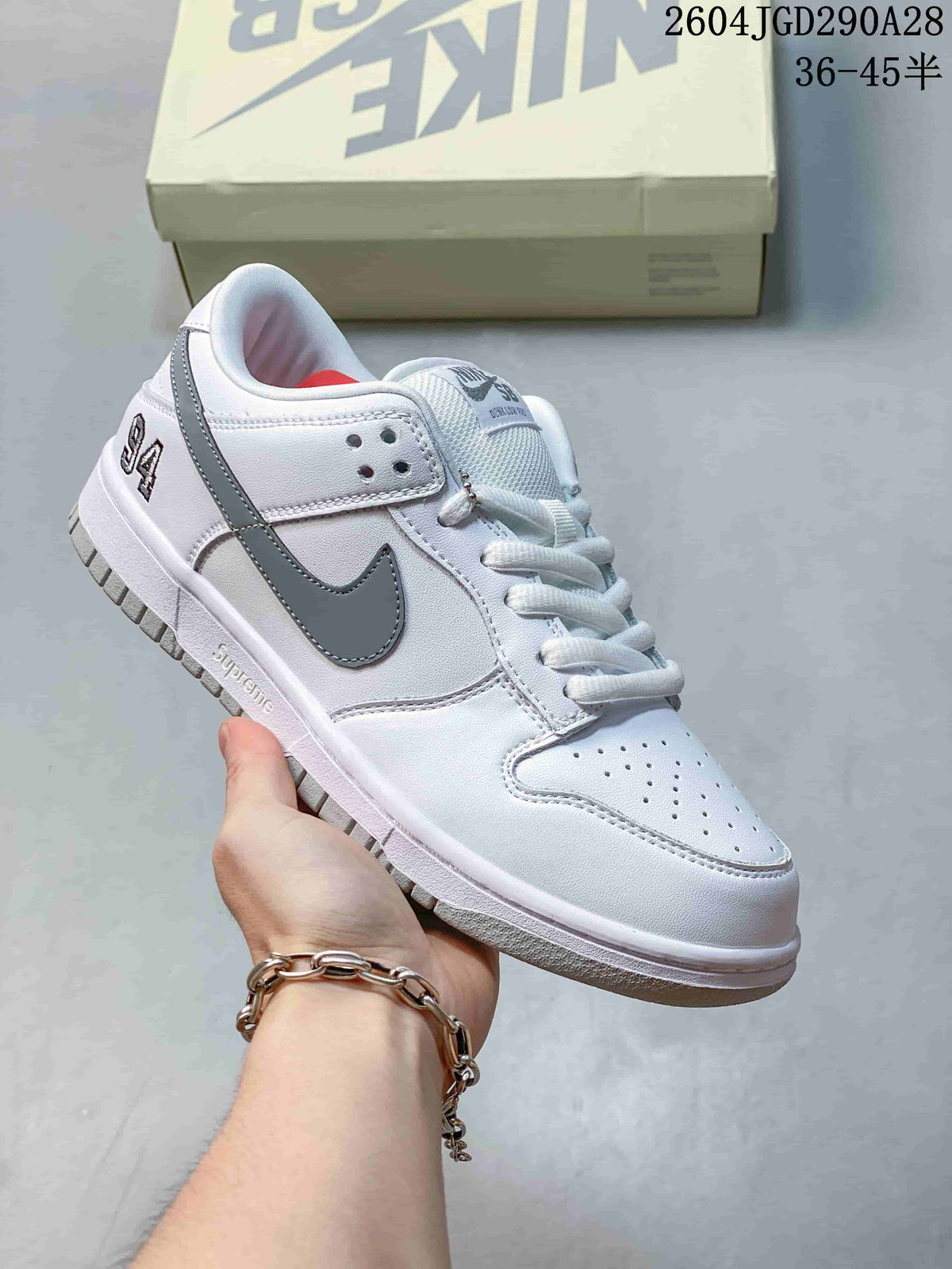 White low-top sneaker with gray accents and white laces