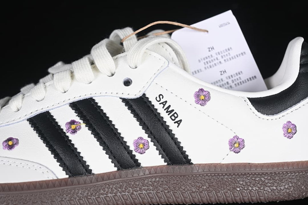 Close-up of black stripes, Samba branding, and purple floral embroidery