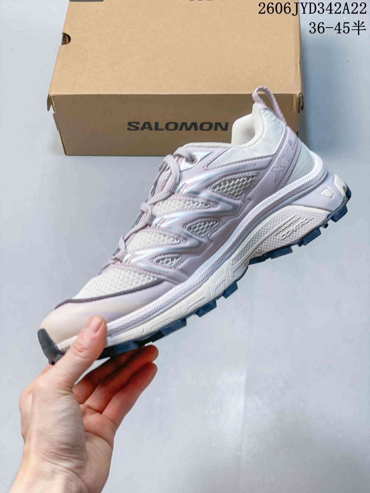 Side view of the white and pale lavender sneaker