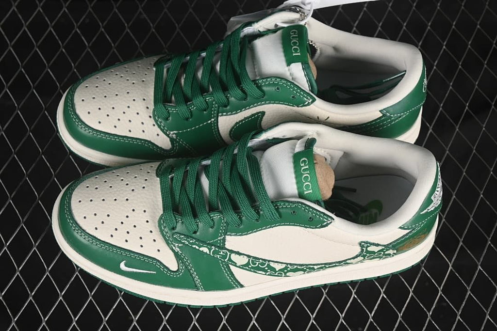 Top view of a pair of cream and green low-top sneakers showing green laces and perforated toe panels.
