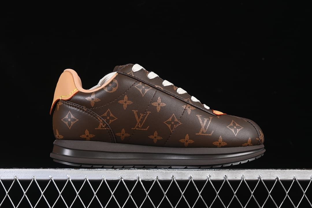 Side profile of a dark brown patterned low-top sneaker.