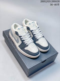 Pair of white, dark blue, and gray Air Jordan 1 Low sneakers on a shoebox