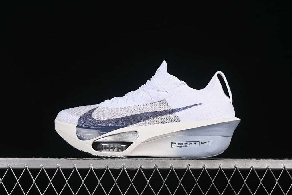 Side profile of the white shoe with oversized navy Swoosh