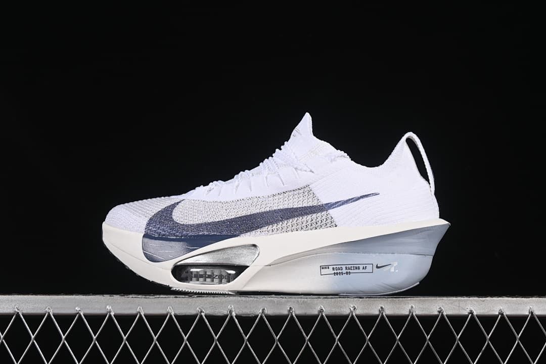 Side profile of the white shoe with oversized navy Swoosh