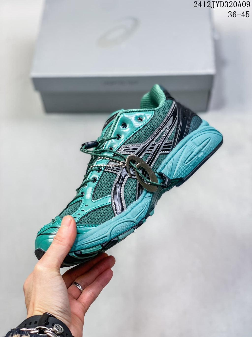 Side view of a teal mesh ASICS sneaker with dark overlays and lace toggle; image text shows 36–45 and 2412JYD320A09.