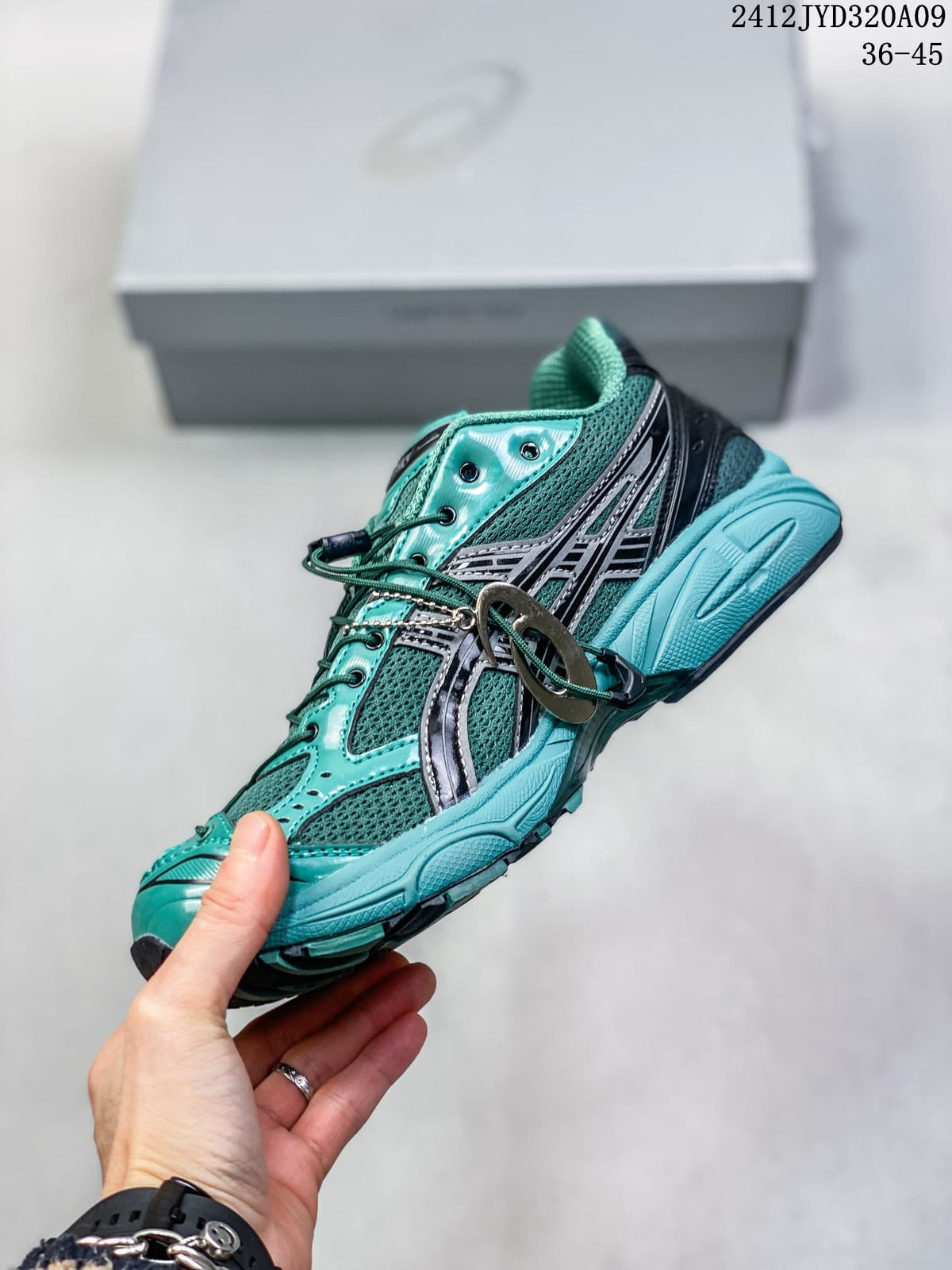 Side view of a teal mesh ASICS sneaker with dark overlays and lace toggle; image text shows 36–45 and 2412JYD320A09.