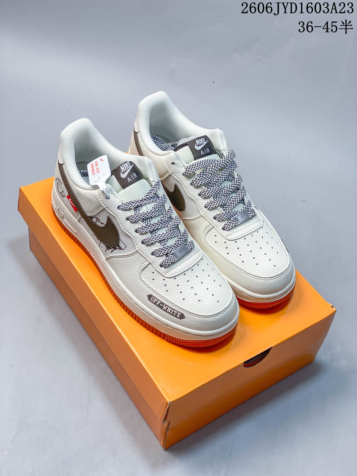 Pair of off-white low-top sneakers with gray accents, patterned laces, and orange outsoles