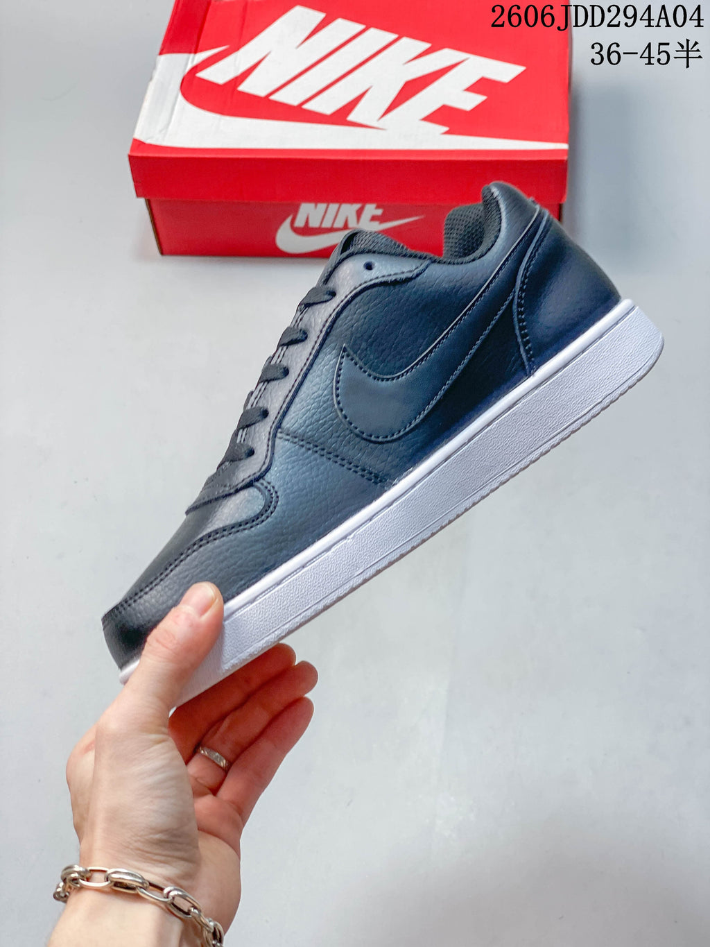 Side profile of the dark gray low-top sneaker with a white outsole