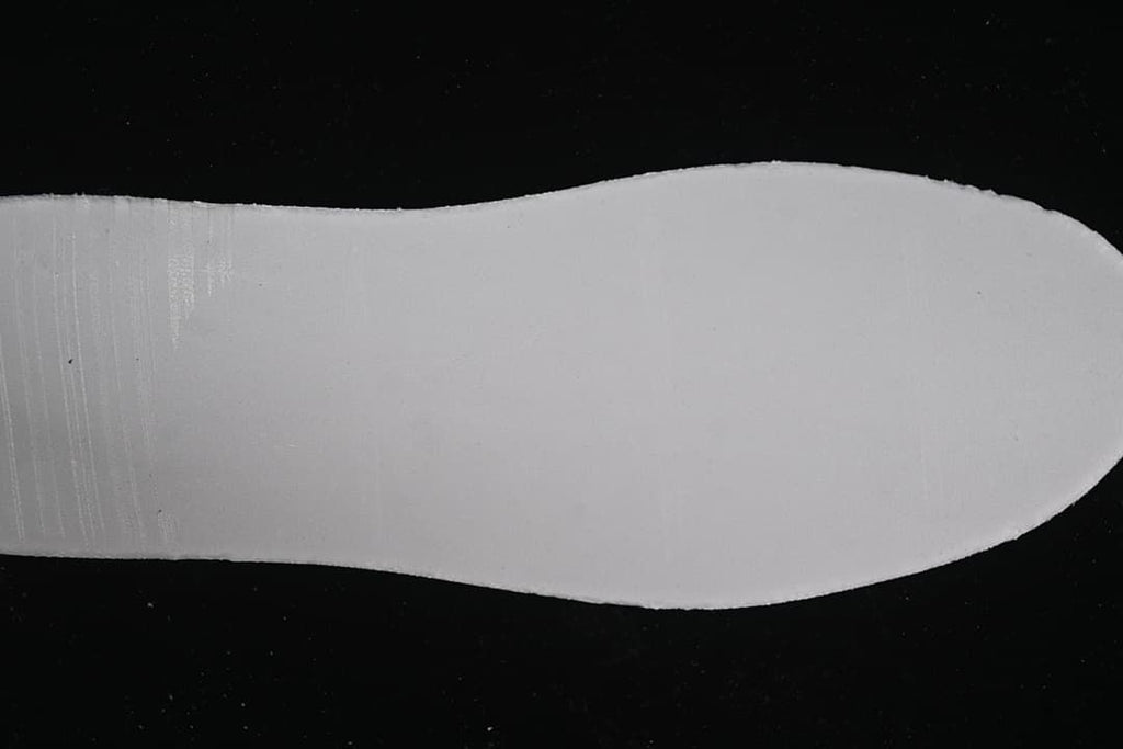 Plain white shoe sole shown against a dark background