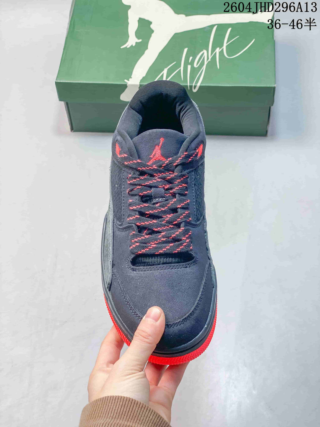 Front view showing the navy toe, red-accented laces, and padded tongue.