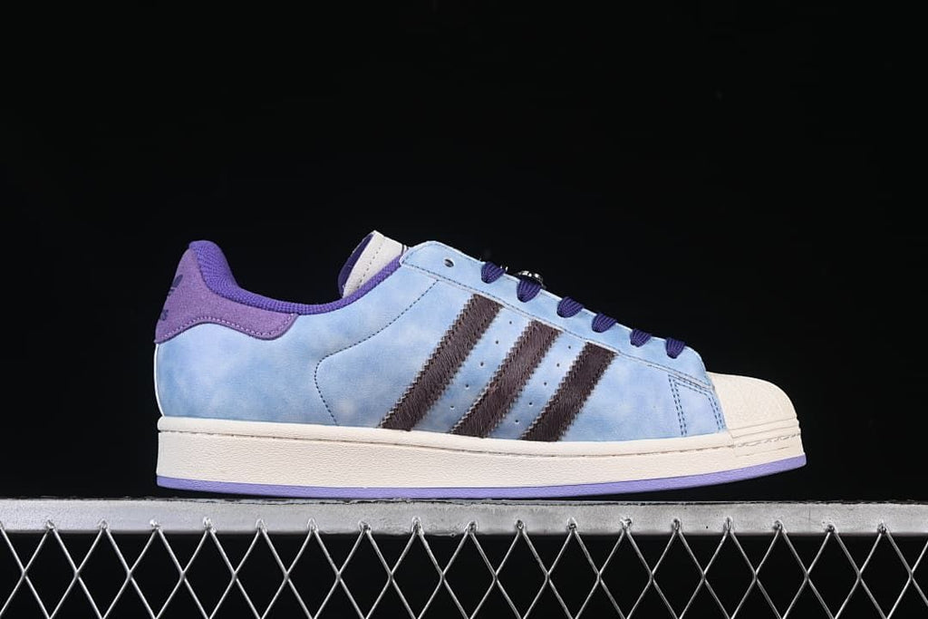 Side profile highlighting the light blue upper, dark stripes and off-white sole
