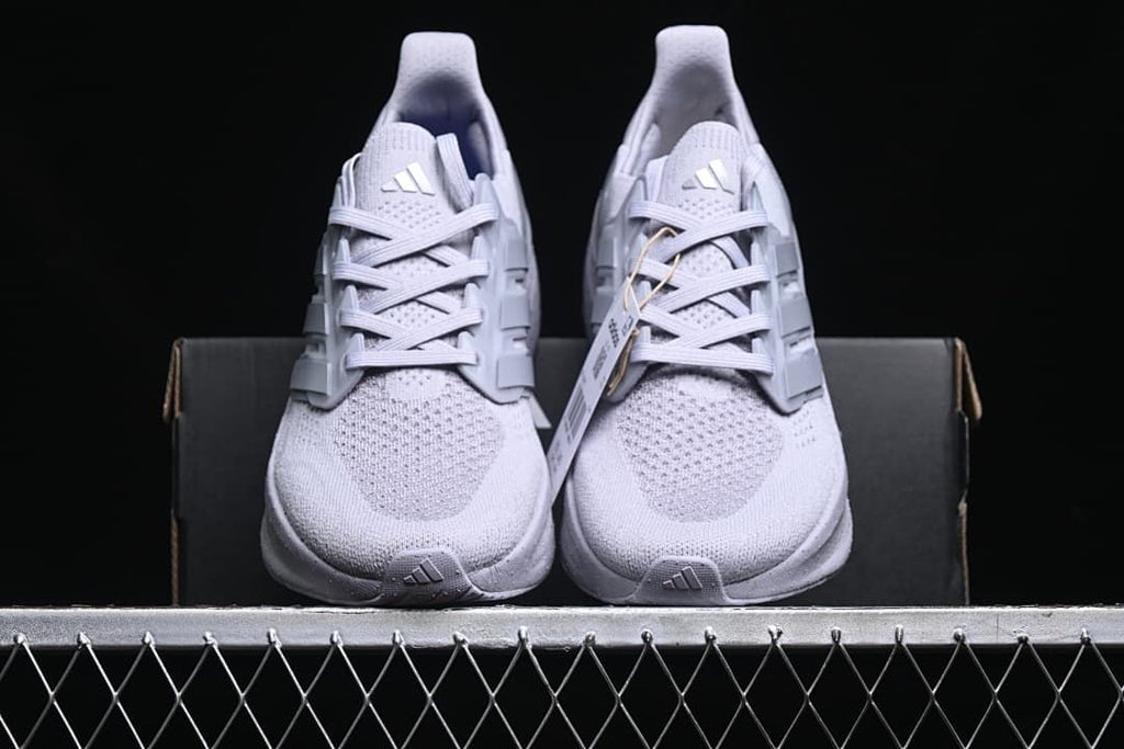 Front view of the pair of light grey running shoes