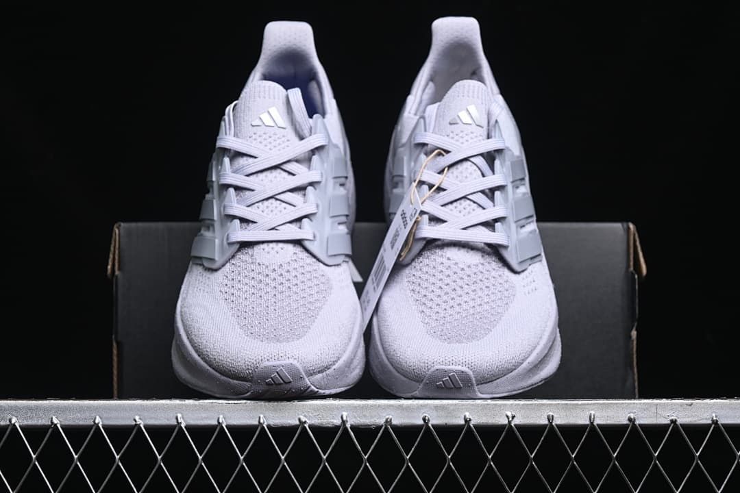 Front view of the pair of light grey running shoes