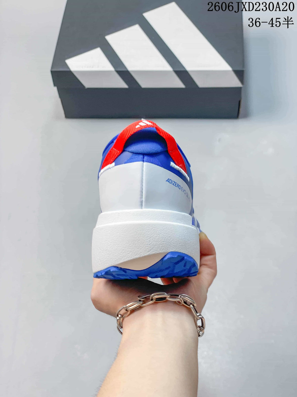Rear view of a blue and white Adidas Adizero Evo SL shoe with red heel pull tab