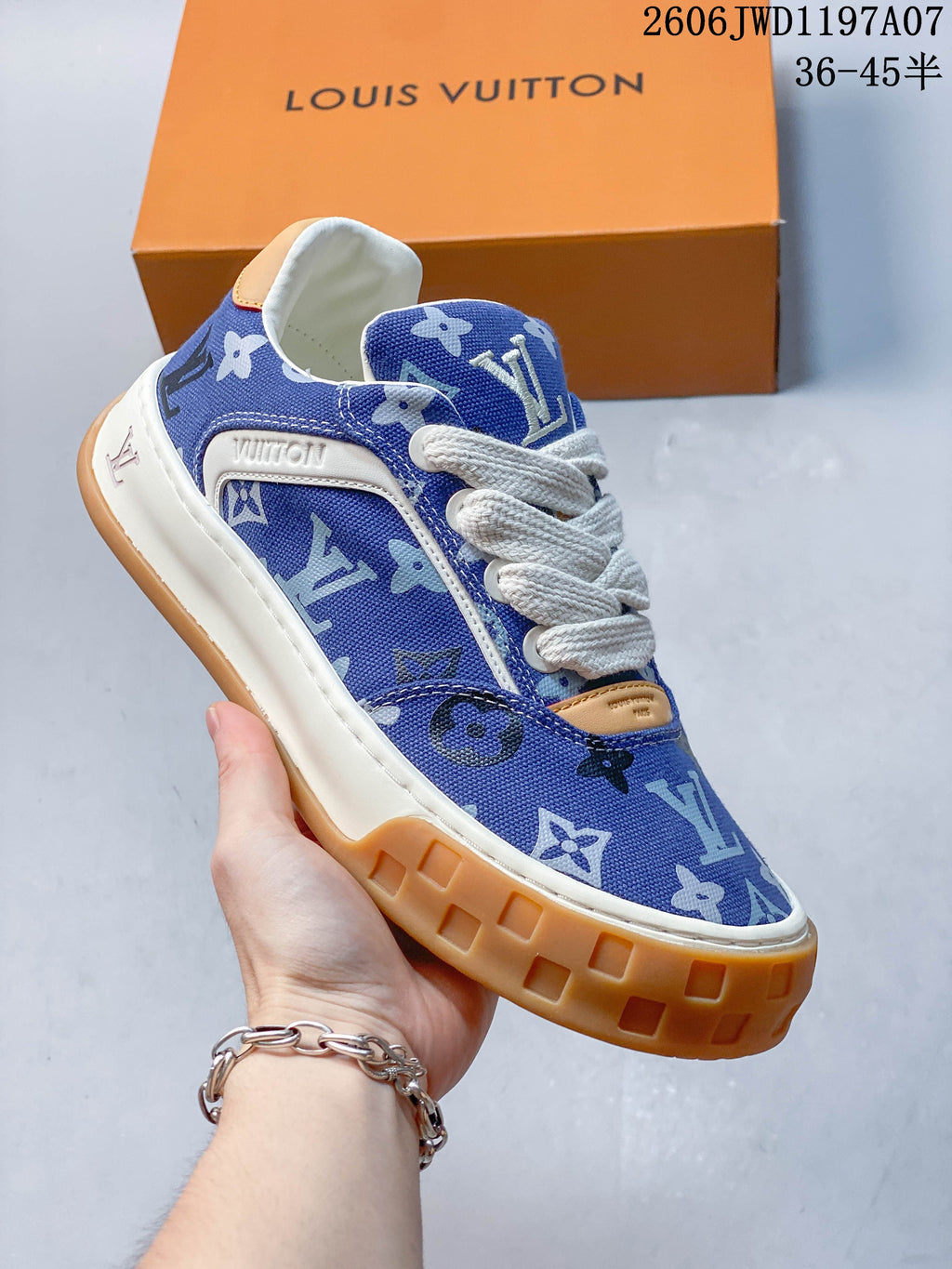 Angled side view of the blue patterned lace-up sneaker with white trim and gum-colored outsole