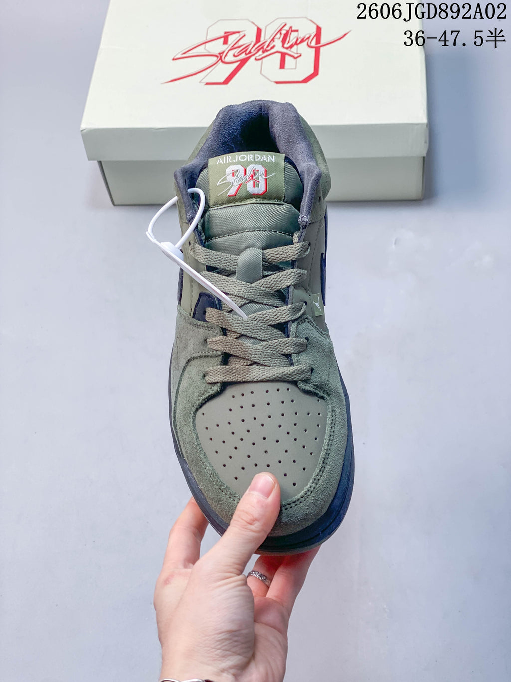 Front view of the perforated toe and laces on a Jordan Stadium 90 sneaker.