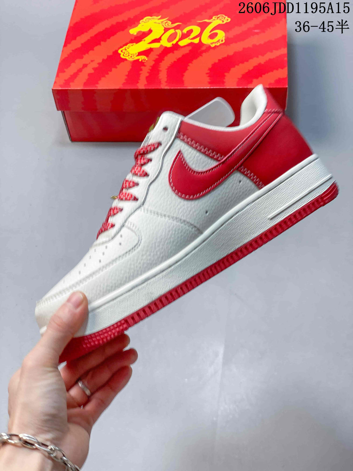 Side view of a white and red low-top sneaker with a patterned Swoosh accent