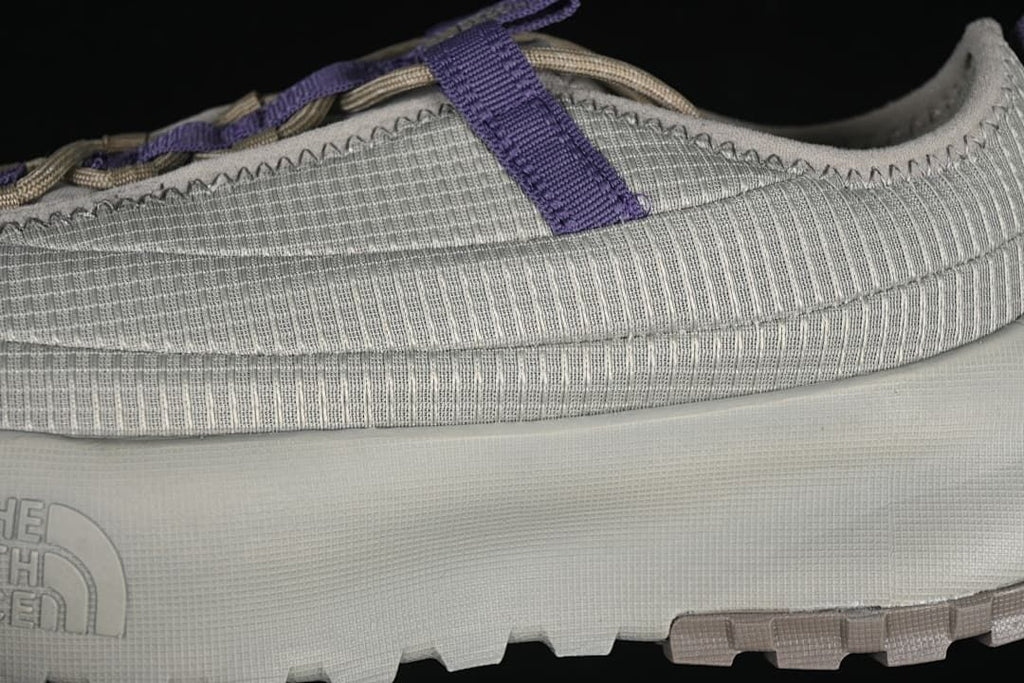 Close-up of the ribbed upper, purple strap and sole.