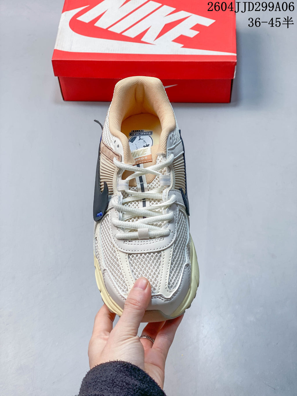Top-down view of a Nike Zoom Vomero 5 sneaker showing its laces, mesh panels and padded collar.