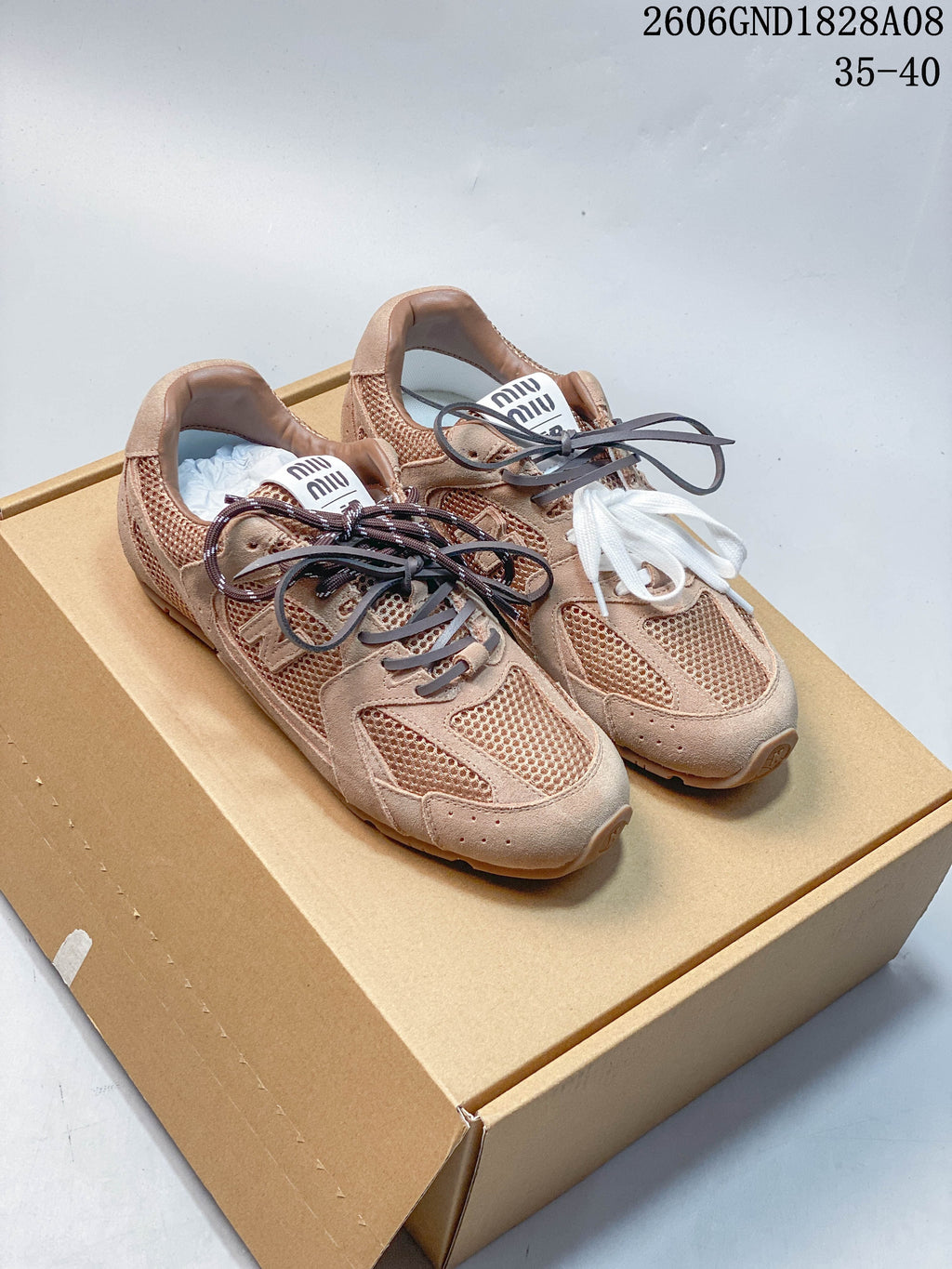 Tan and muted green low-top sneakers with mesh panels and contrasting laces, photographed from above.
