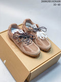 Tan and muted green low-top sneakers with mesh panels and contrasting laces, photographed from above.